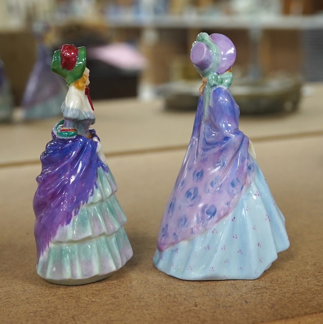 Two Royal Doulton M-series figures, M2 A Victorian Lady and M3 The Paisley shawl, 10cm high. Condition - one repaired